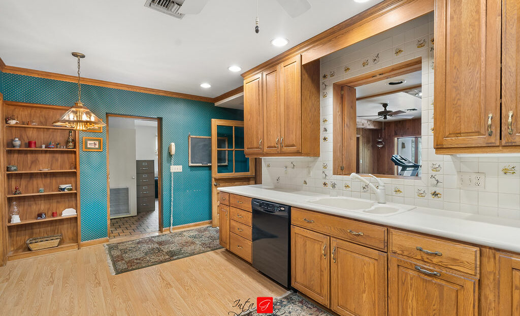 A kitchen with wood cabinets and blue walls.